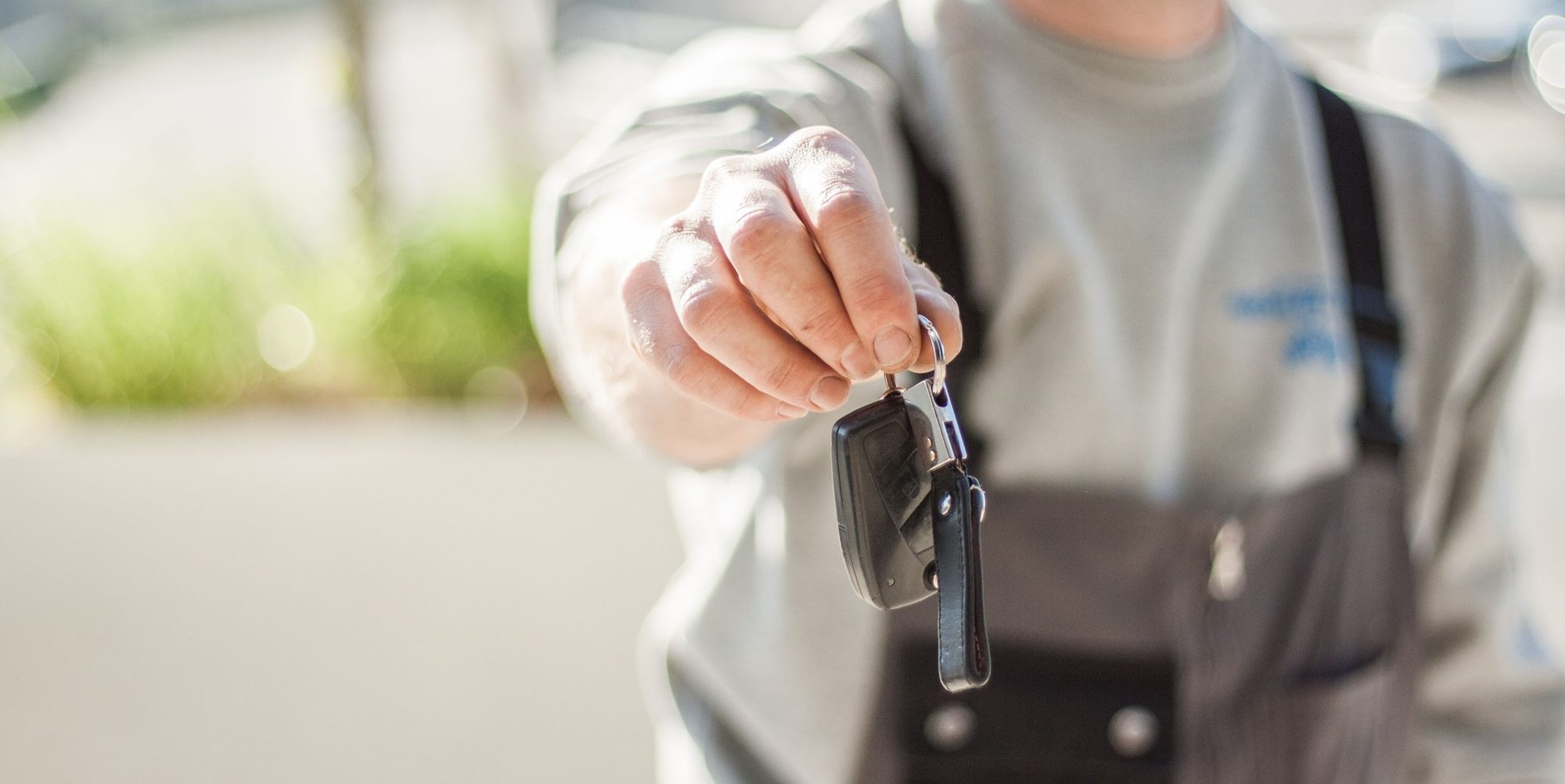 a man handing the car keys